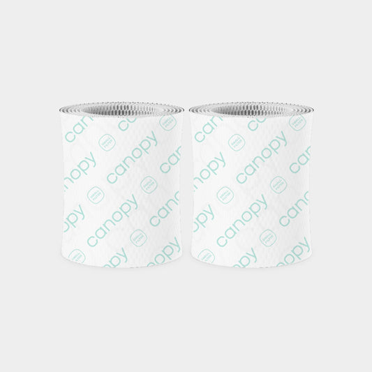 Bedside Humidifier Duo Filter 2.0 2-Pack featuring two cylindrical blue filters with textured circular pattern design and white mesh tops, designed for efficient water filtration and bacteria removal in Canopy humidifiers