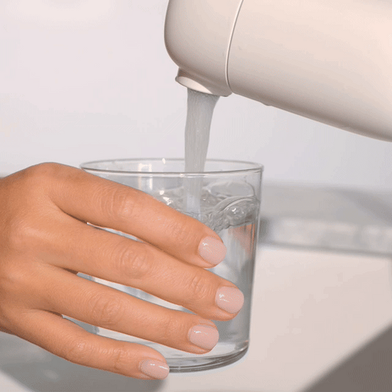 GIF of model pouring a glass of water from the Faucet Filter in White and drinking it followed by her daughter also filling up a glass of water from the Faucet Filter in White