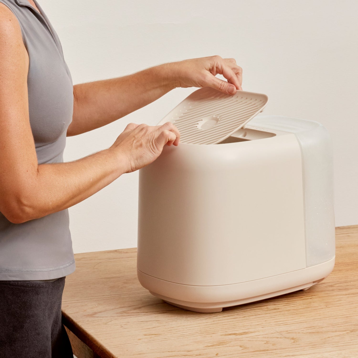 Large Room Humidifier | Lifestyle, Woman lifting the grate off the device