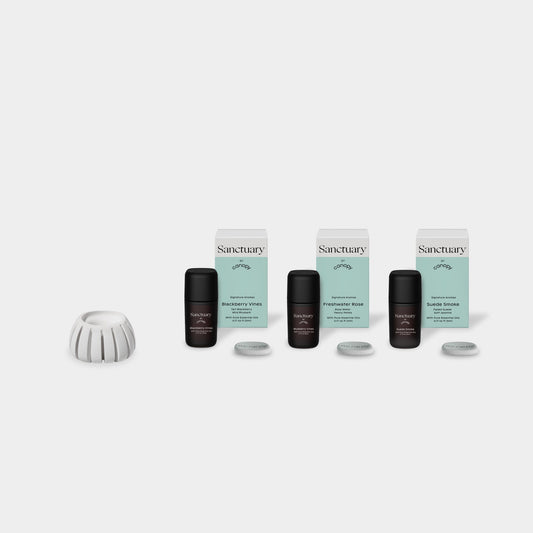 Diffusion Well & Aroma Kit featuring a white ceramic diffuser base with three Sanctuary essential oil bottles in sleek black packaging, accompanied by mint-colored boxes and silver diffuser pads for optimal aromatherapy experience by Canopy