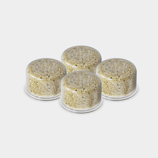 Showerhead Filter Bundle featuring 4 premium cylindrical water filtration cartridges in beige with natural mineral particles, designed to remove impurities and enhance water quality for a spa-like shower experience - by Canopy