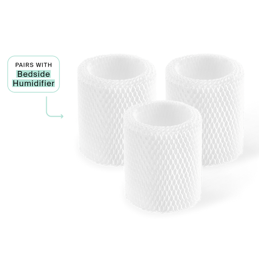 Three white cylindrical Bedside Humidifier Filters with mesh-like texture arranged in a group, showing their antimicrobial design. A small label indicates compatibility with Bedside Humidifier model.