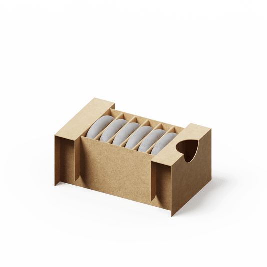 Aroma Stone 6-Pack featuring six cylindrical ceramic diffuser stones neatly arranged in a kraft paper storage box with protective dividers and side handles for easy transport