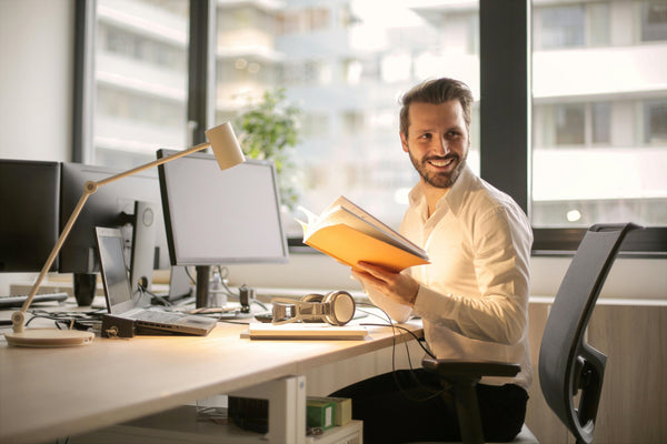 Man at office workspace with computer equipment