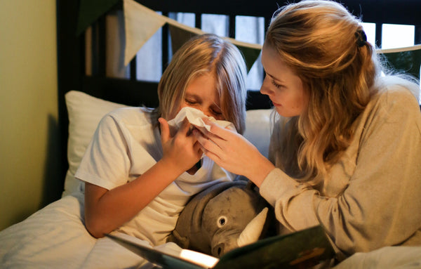 Mother tending to child with the flu