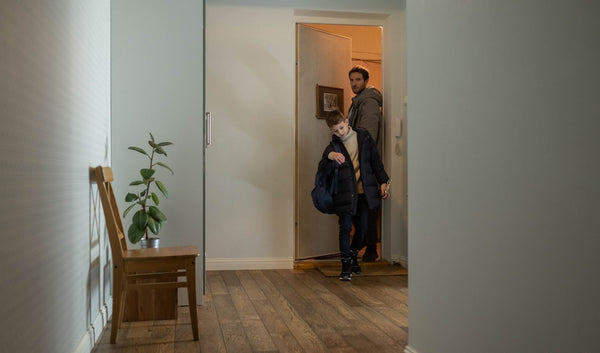 Father and son entering apartment