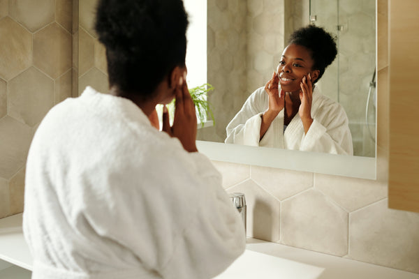 Woman in bathrobe preparing for morning shower