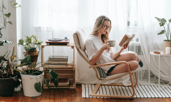 Woman reading by the windows on a sunny day