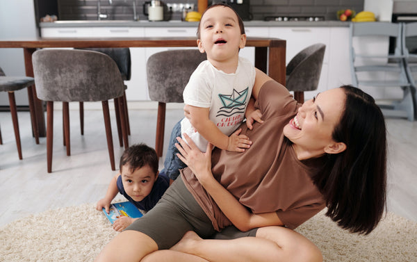 Woman playing with two young sons