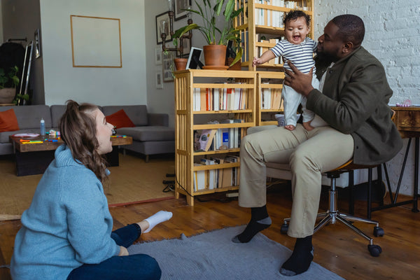 Mother and father playing with baby at home
