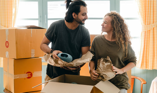 Couple unpacking boxes in new apartment