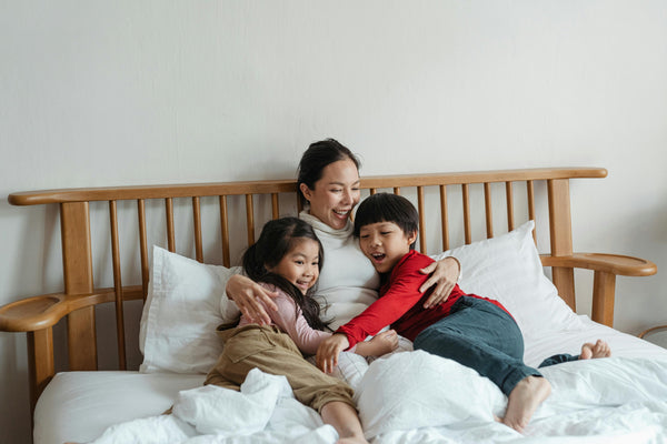 Mother and young children relaxing at home