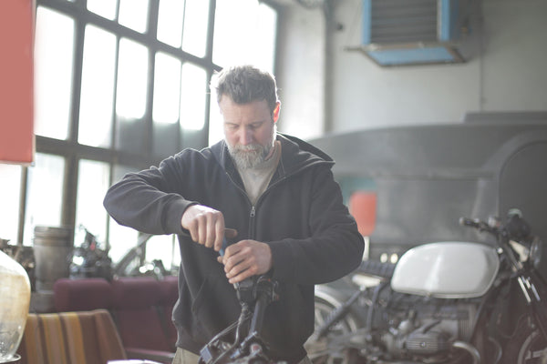 Man working on motorcycle in garage