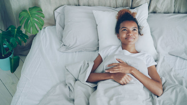 Young woman lying in bed after a restful night's sleep