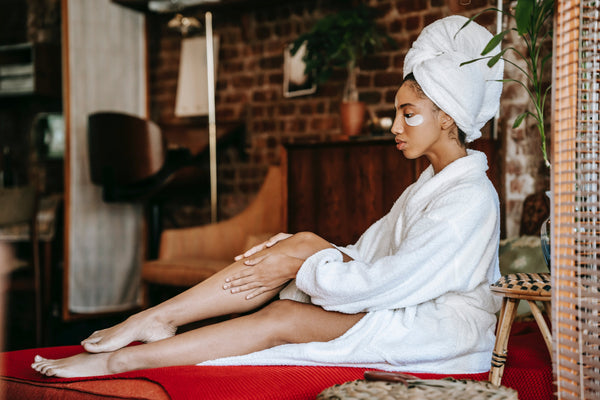 Woman treating dry skin at home