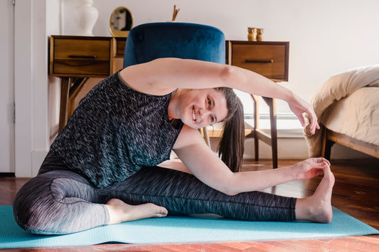 Woman relaxing with yoga at home