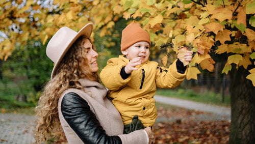 Mother and child enjoying foliage on a fall day