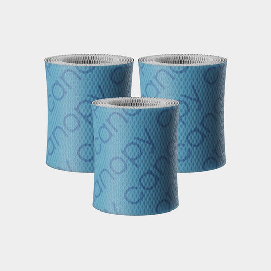 Three cylindrical Bedside Humidifier Bundle Filter 2.0 replacement filters in light blue with textured antimicrobial surface pattern and silver mesh tops, arranged in a triangular formation against a white background.