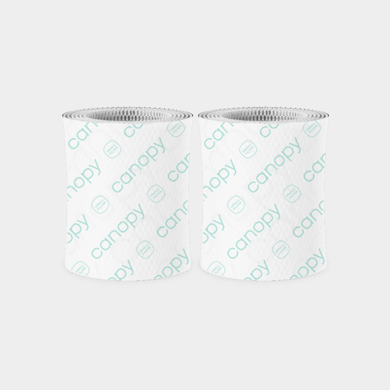 Bedside Humidifier Duo Filter 2.0 2-Pack featuring two cylindrical blue filters with textured circular pattern design and white mesh tops, designed for efficient water filtration and bacteria removal in Canopy humidifiers