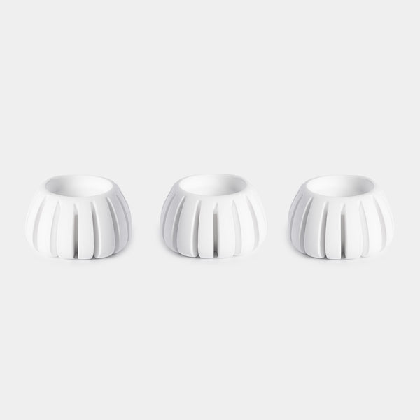 Three white ceramic Diffusion Well vessels arranged in a row against a white background, designed for long-lasting aromatherapy diffusion with the Canopy Diffuser. Diffusion Well 3-Pack by Canopy.