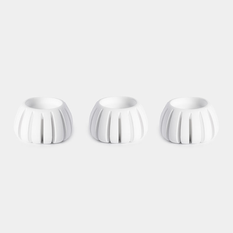 Three white ceramic Diffusion Well vessels arranged in a row against a white background, designed for long-lasting aromatherapy diffusion with the Canopy Diffuser. Diffusion Well 3-Pack by Canopy.