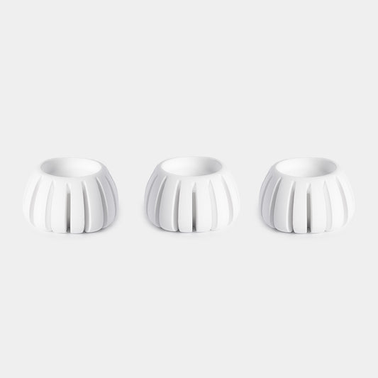 Three white ceramic Diffusion Well vessels arranged in a row against a white background, designed for long-lasting aromatherapy diffusion with the Canopy Diffuser. Diffusion Well 3-Pack by Canopy.