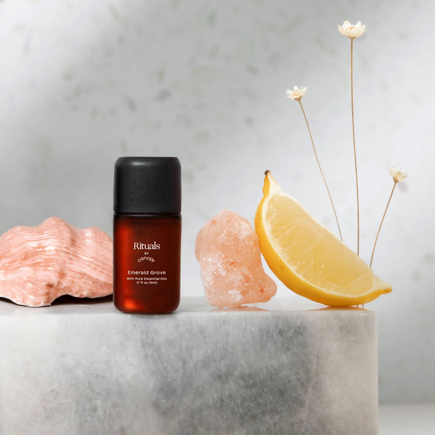Emerald Grove Aroma | Lifestyle, Rituals Aroma Bottle with a lemon wedge and decorative elements on a marble surface