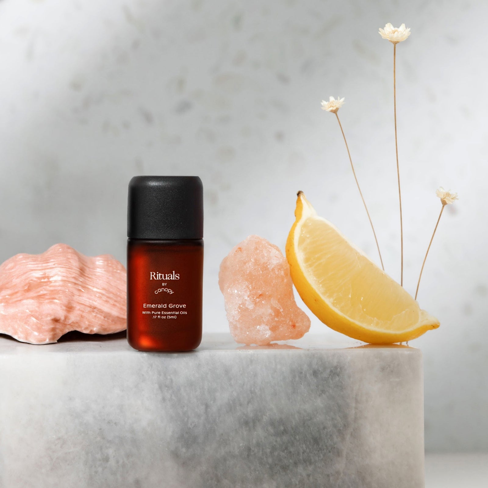 Emerald Grove Aroma | Lifestyle, Rituals Aroma Bottle with a lemon wedge and decorative elements on a marble surface