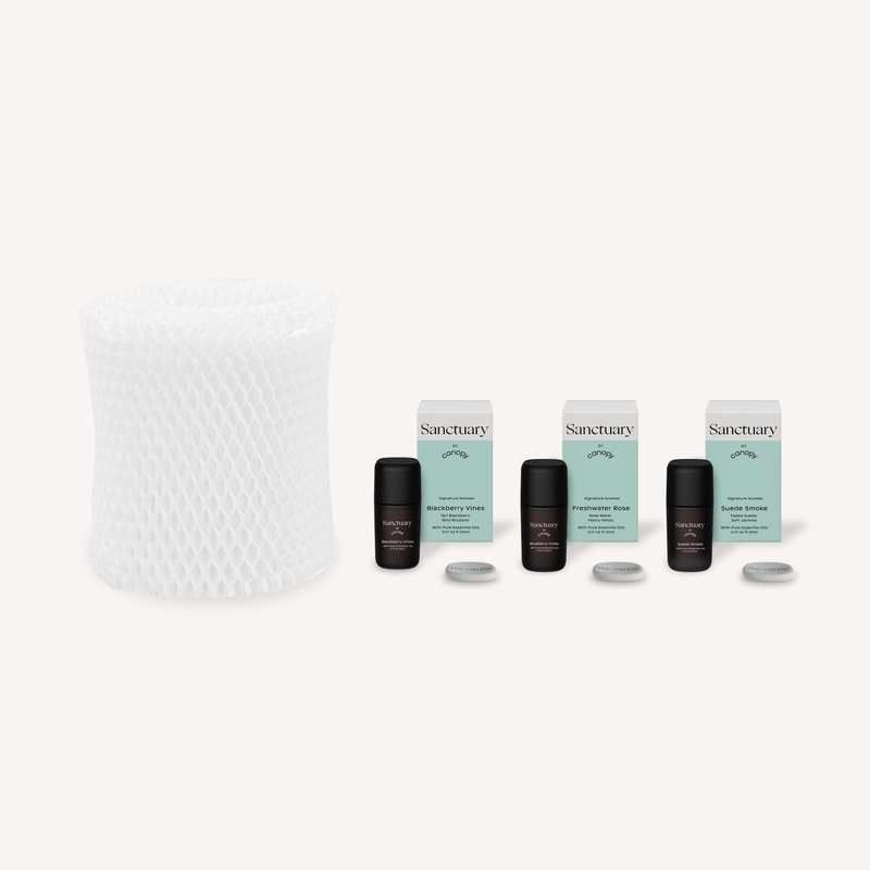 Bedside Humidifier Filter & Aroma set featuring a white mesh replacement filter alongside three Sanctuary essential oil bottles with mint-colored packaging and aromatherapy tablets for optimal air moisture and fragrance diffusion
