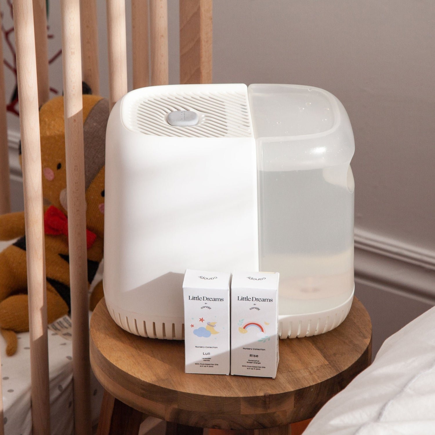 Nursery Humidifier | Lifestyle, White Nursery Humidifier with Little Dreams Aroma Kit next to a crib