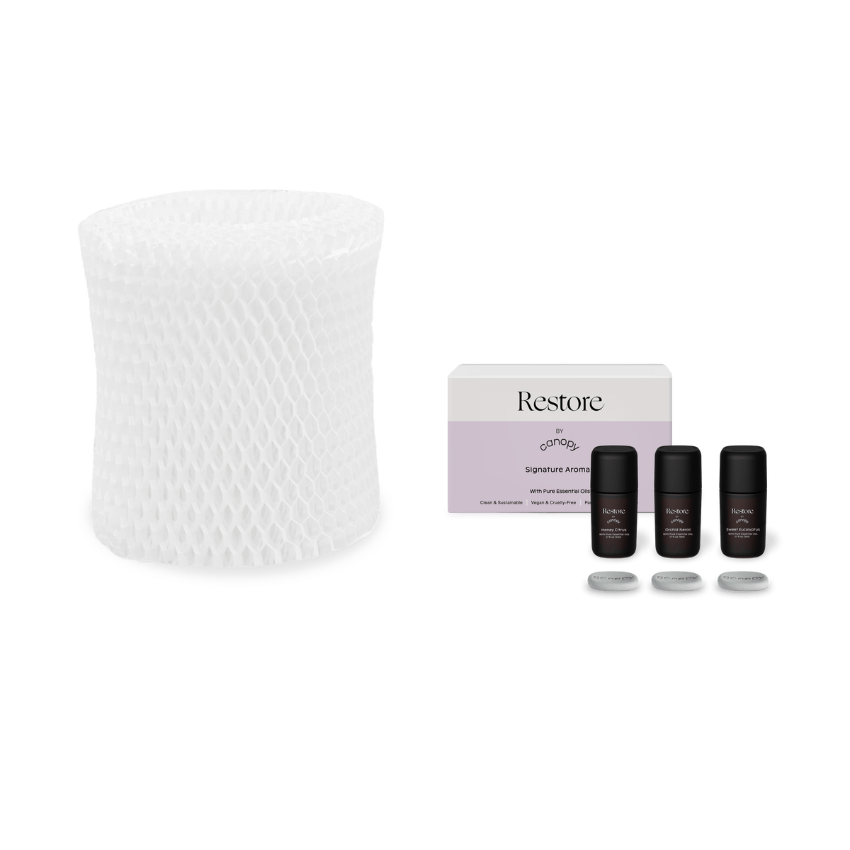 White humidifier filter paired with three Restore Aroma essential oil bottles in sleek black packaging, featuring replaceable filters for large room air purification and aromatherapy. Restore Aroma + Large Room Filter Subscription by Canopy.