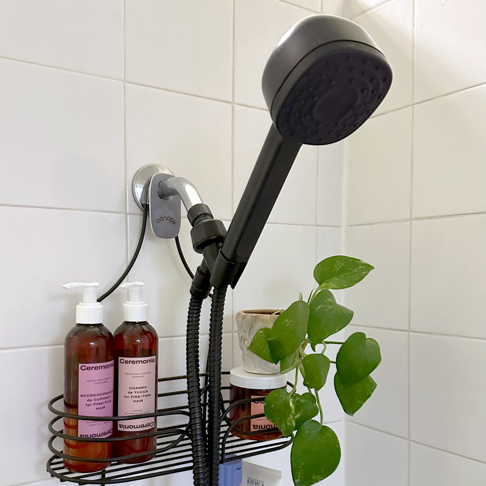 Matte Black handheld showerhead against white tiles