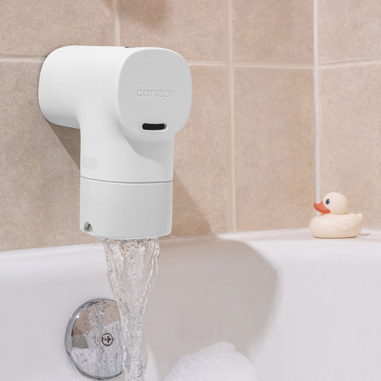 Bath Tub Filter in White installed in a bath tub with beige tile and a rubber duck sitting on the edge