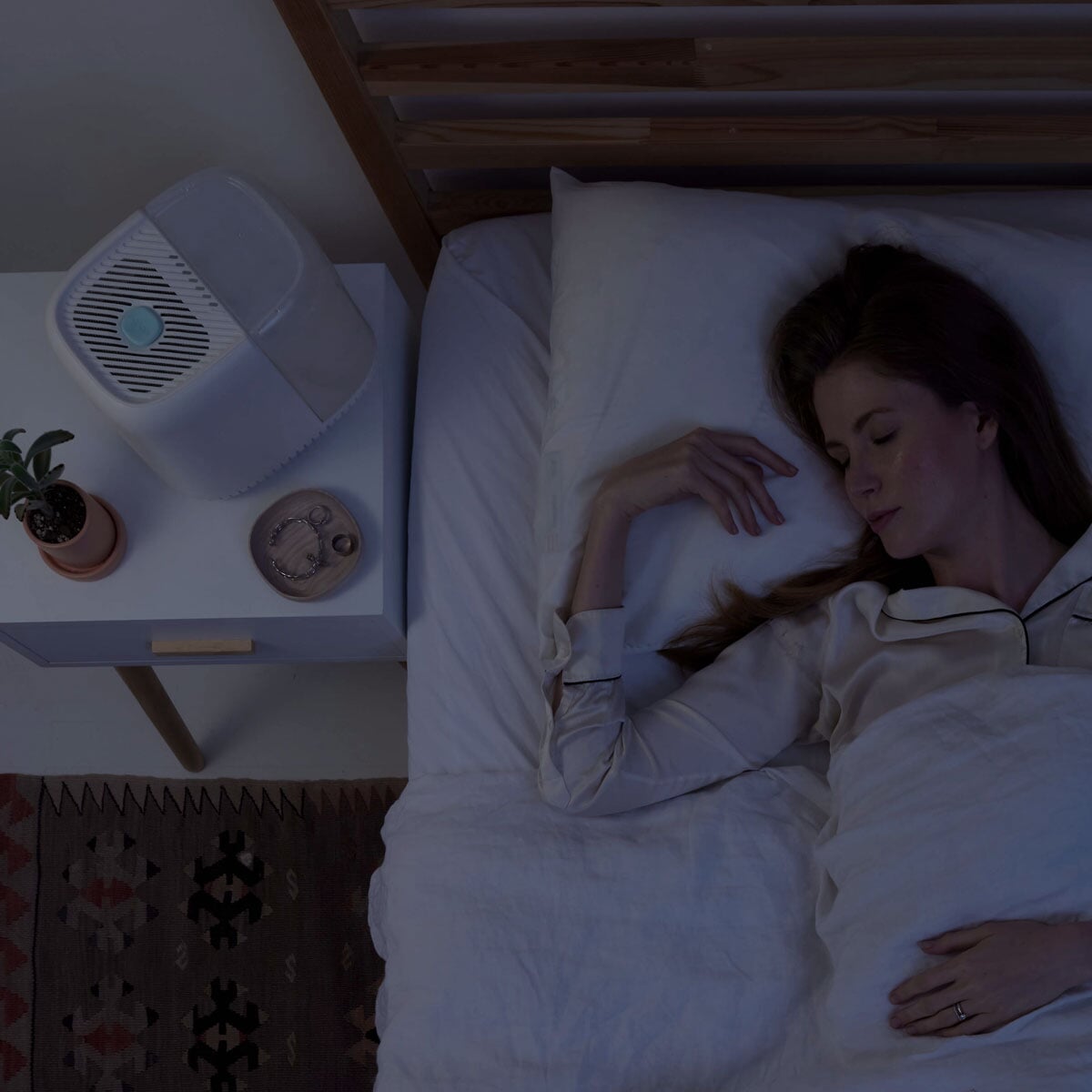 Bedside Humidifier | Lifestyle, Woman sleeping next to a Canopy Bedside Humidifier at night